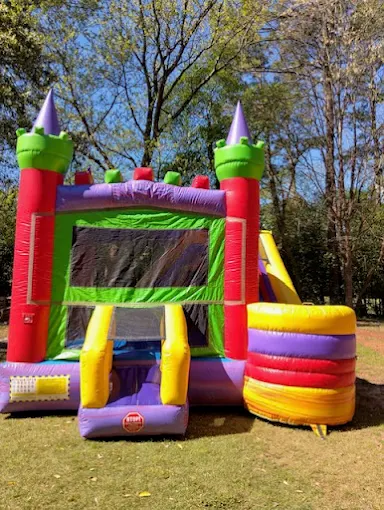 Colorful castle themed bounce house combo with slide