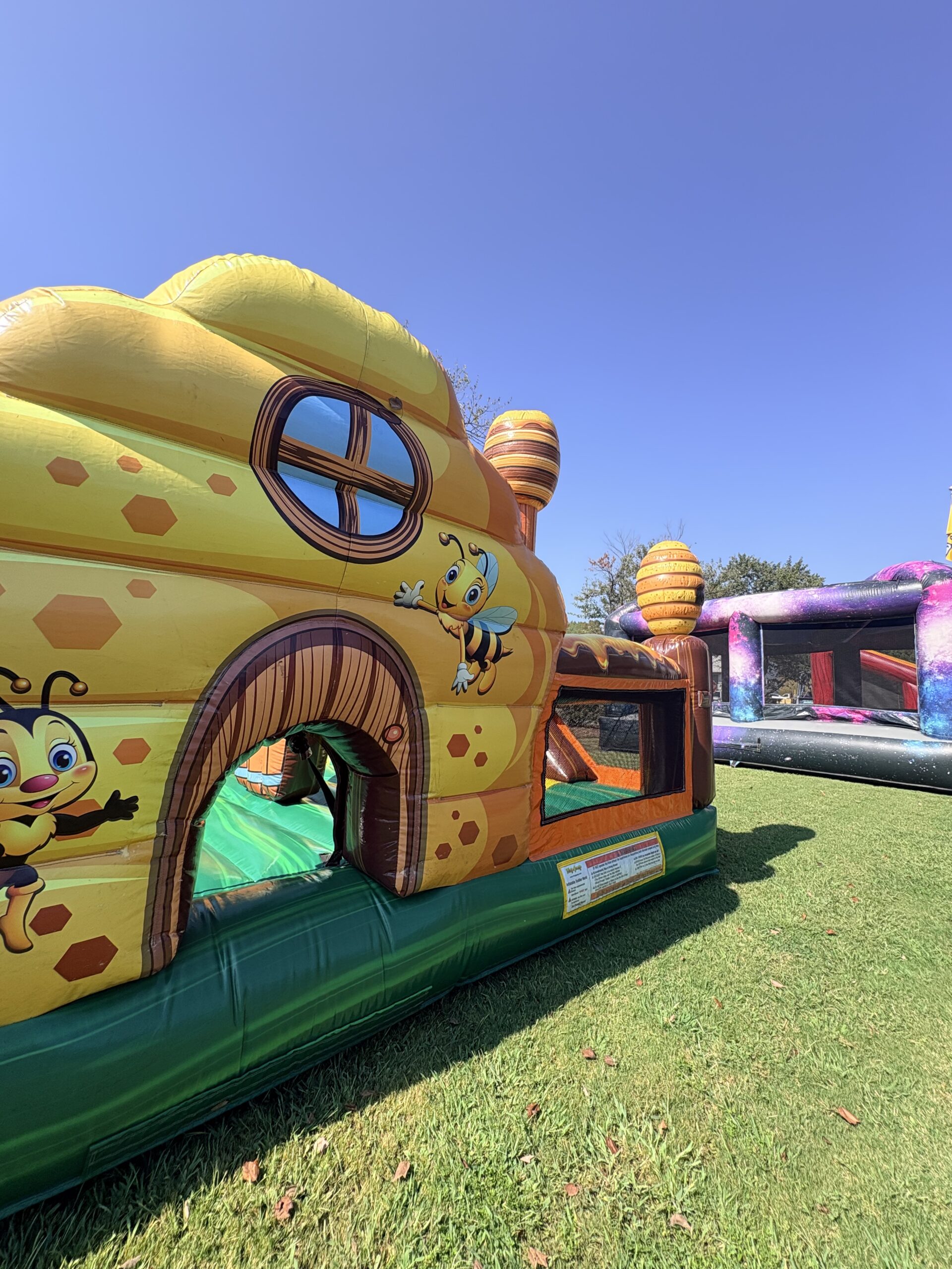 Colorful castle themed bounce house combo with slide